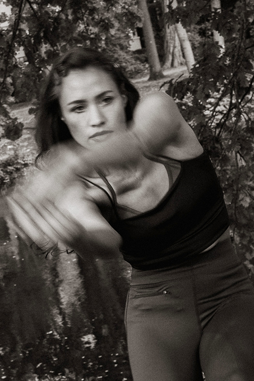 Woman Laura Nguyen Chi actively posing in sports outfit.